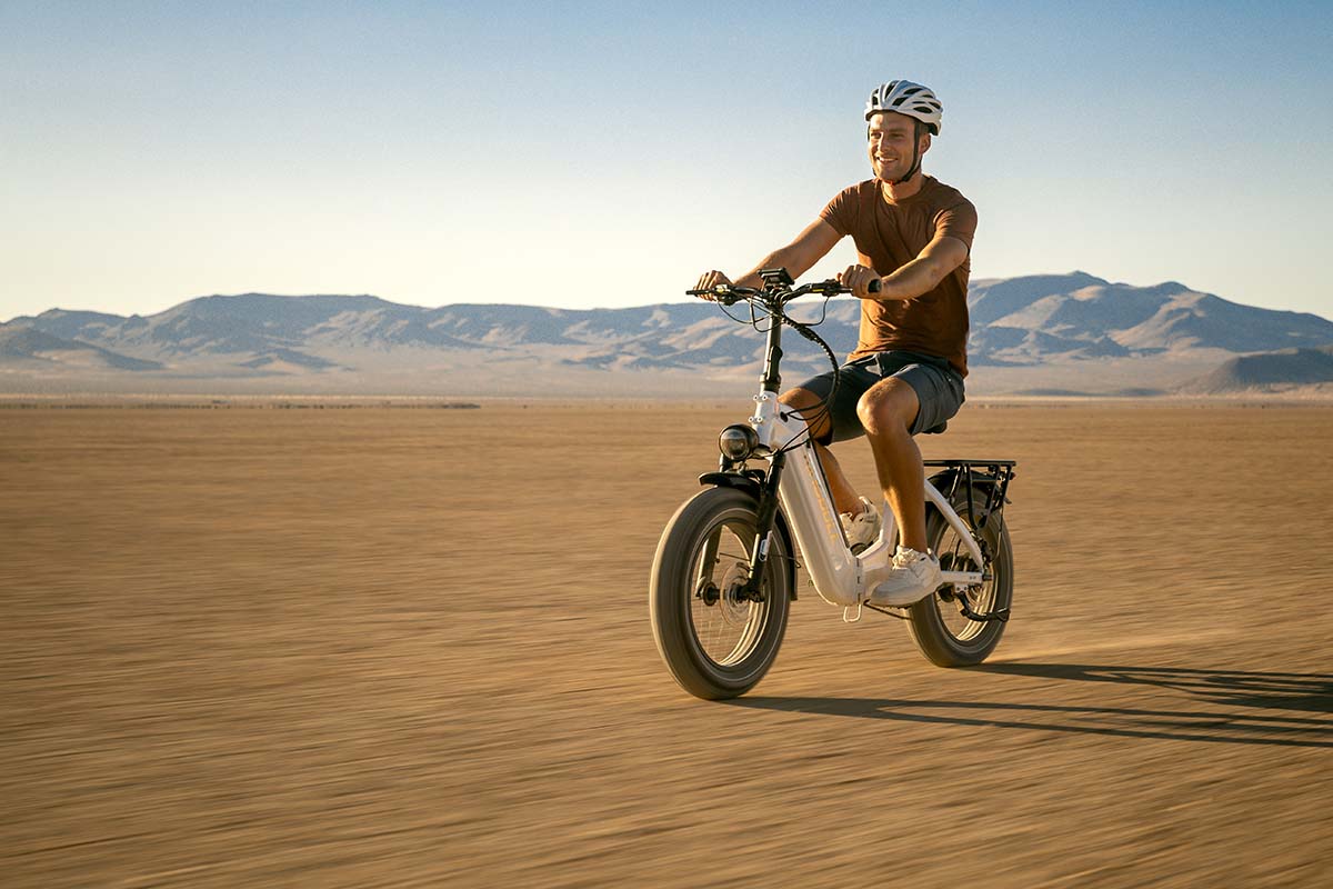 Rider crossing a Mojave dry lake bed at speed on a white Kingbull Verve e-bike, by Niaz Uddin