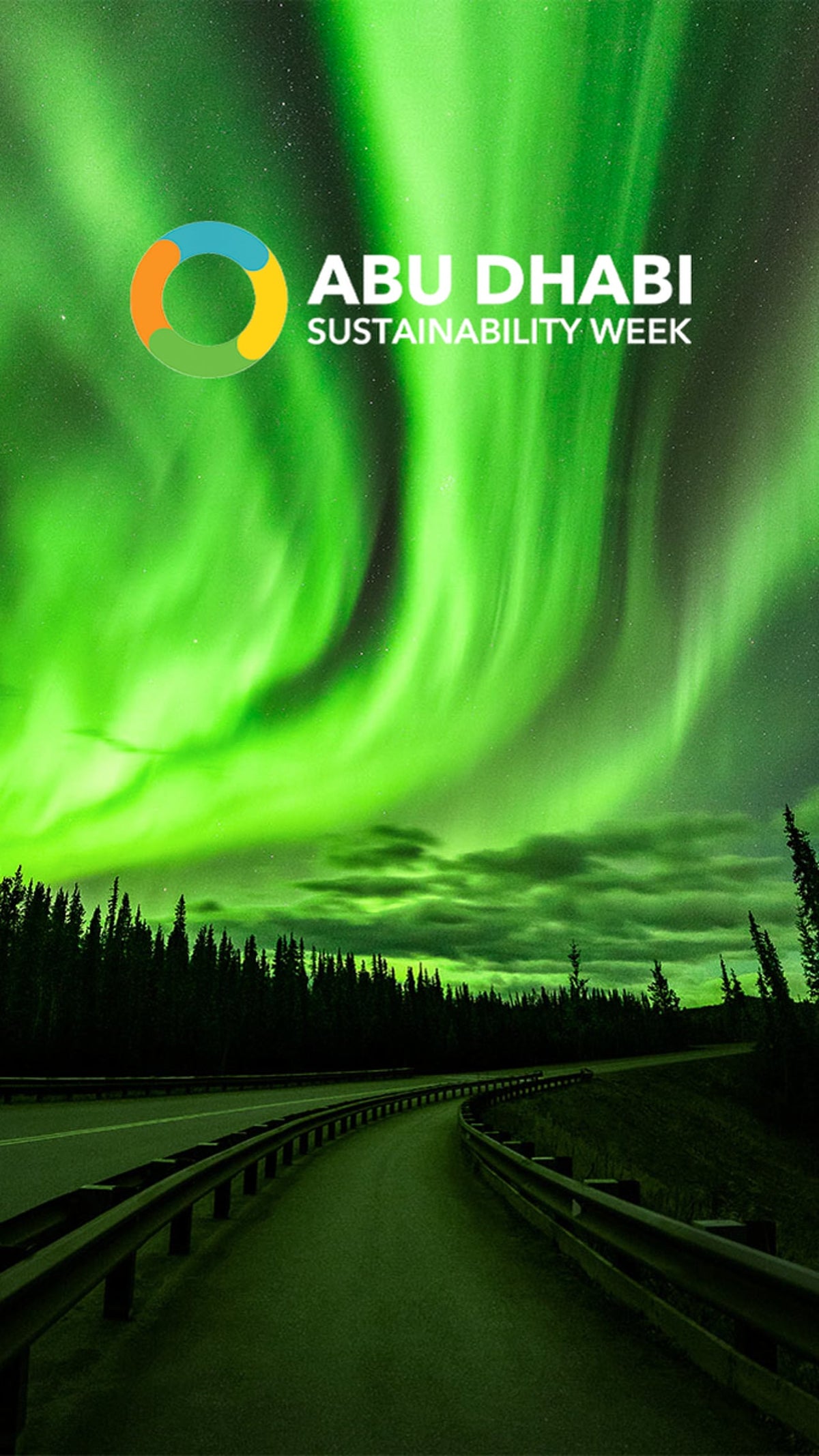 Green aurora over a road cutting through pine forest at night, from the Abu Dhabi Sustainability Week film by Niaz Uddin