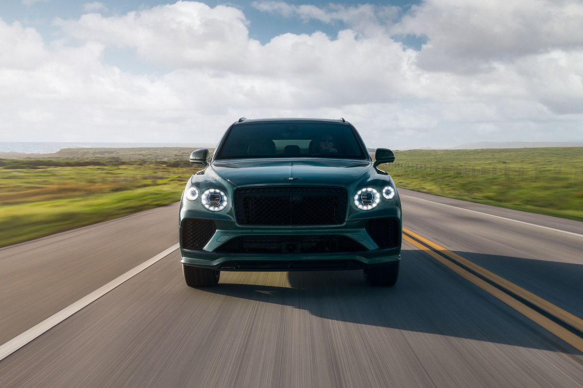 Green Bentley Bentayga rolling shot on a coastal highway, automotive photography by Niaz Uddin
