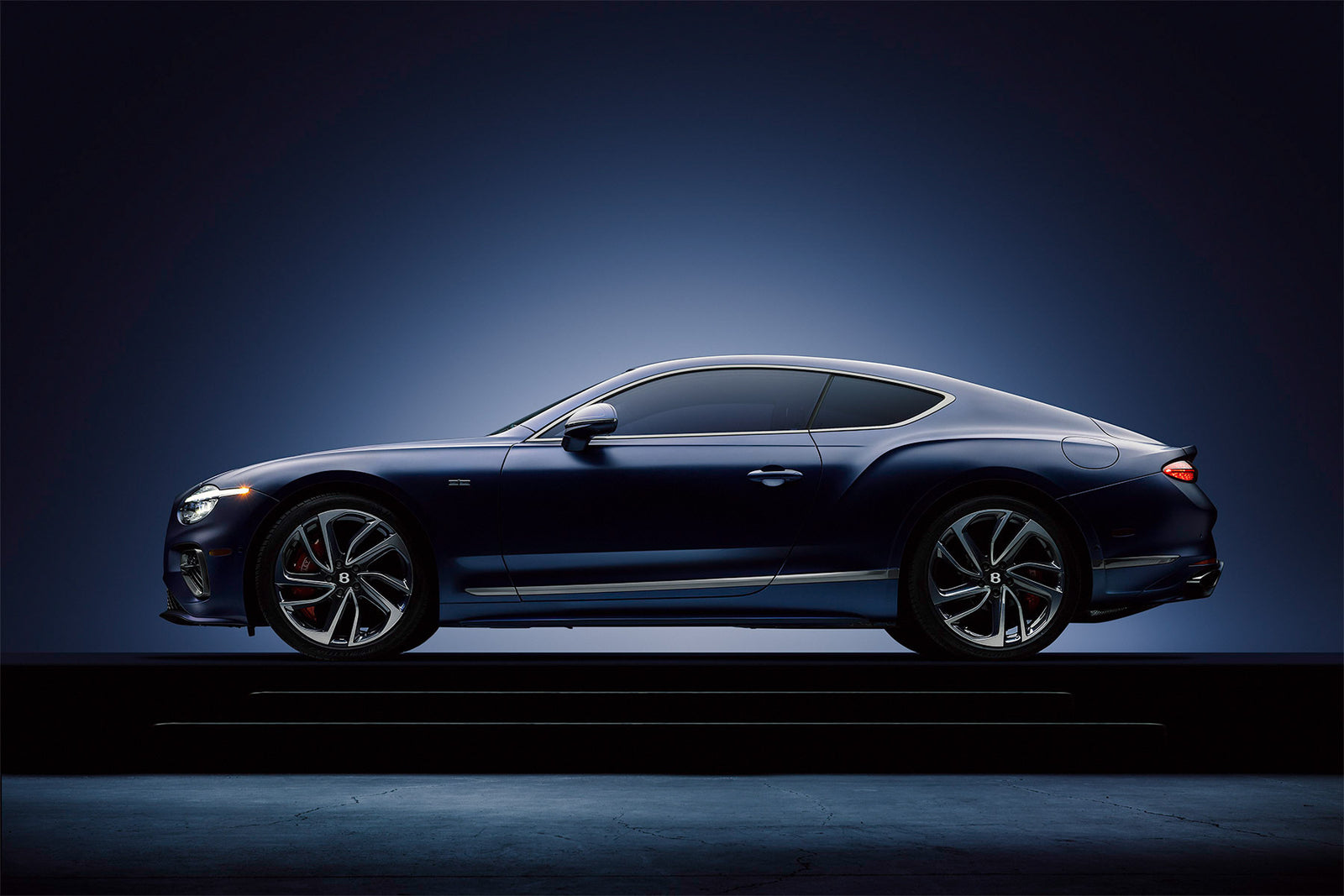 Side profile of a satin blue Bentley Continental GT on a studio plinth, by Niaz Uddin
