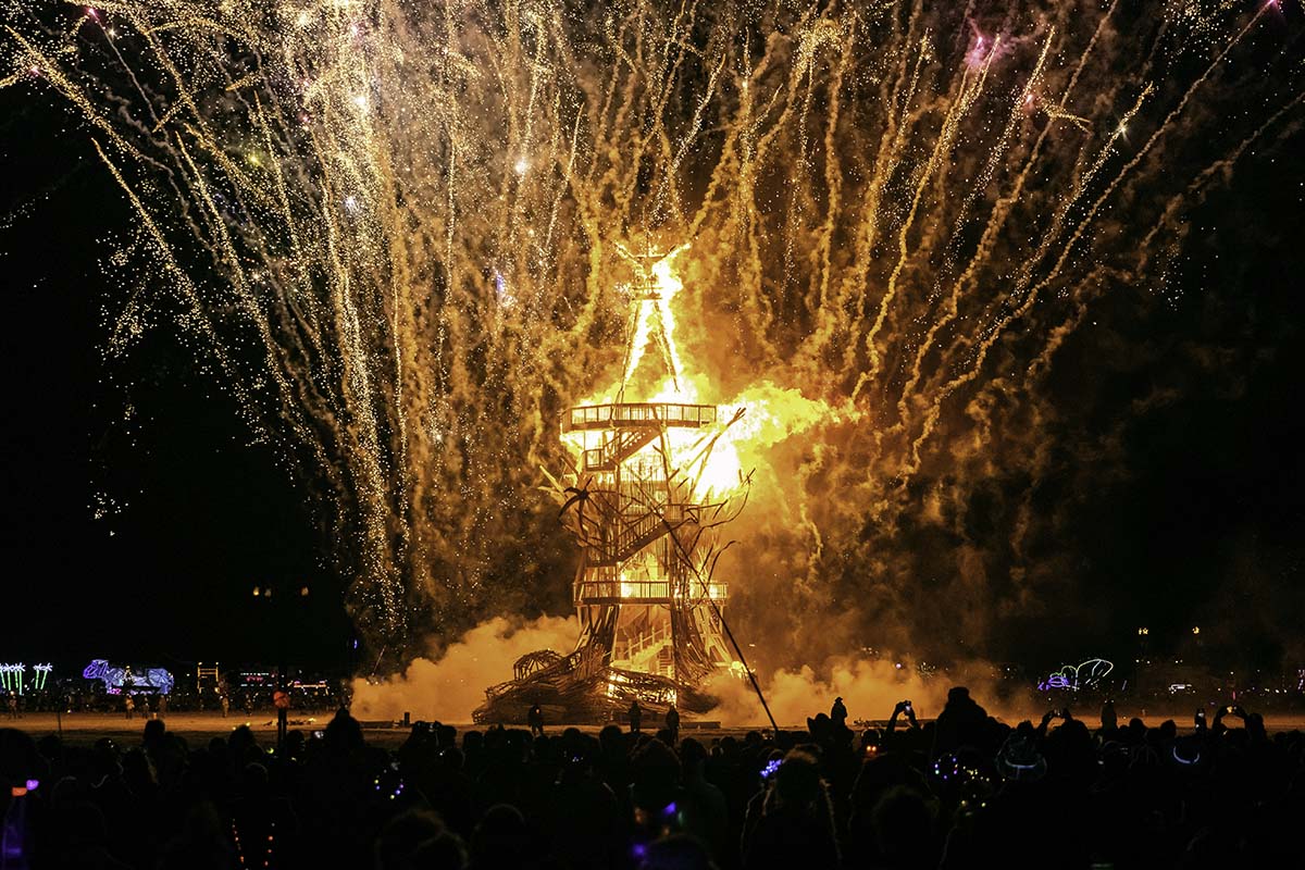 The Man burning under a shower of fireworks as the crowd watches, Burning Man 2026, by Niaz Uddin