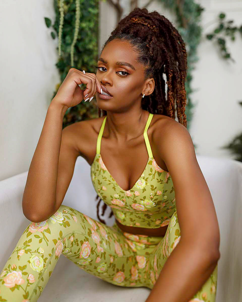 Seated portrait of a model in the POPFLEX Rose Garden green floral set, hand resting at her chin, by Niaz Uddin