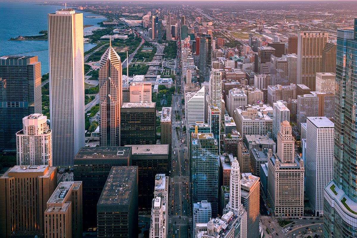Aerial view looking south down Michigan Avenue in Chicago, with the Aon Center, Two Prudential Plaza, Grant Park, and Lake Michigan at dusk, by Niaz Uddin