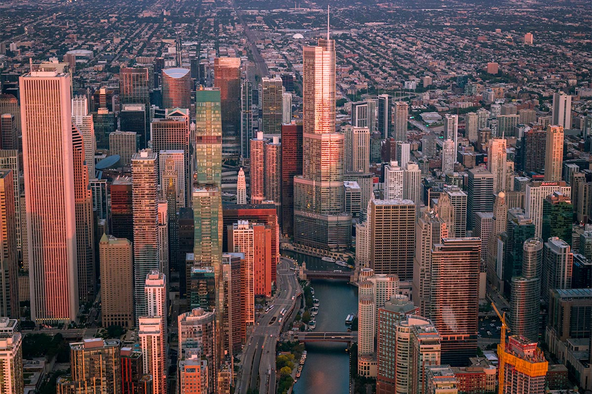 Aerial view of downtown Chicago at sunset with Trump Tower rising above the Chicago River, by Niaz Uddin