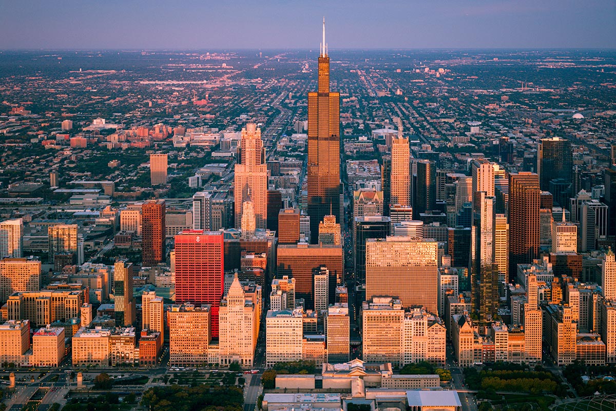 Aerial view of Willis Tower and the Chicago Loop in golden hour light, looking west across the city, by Niaz Uddin