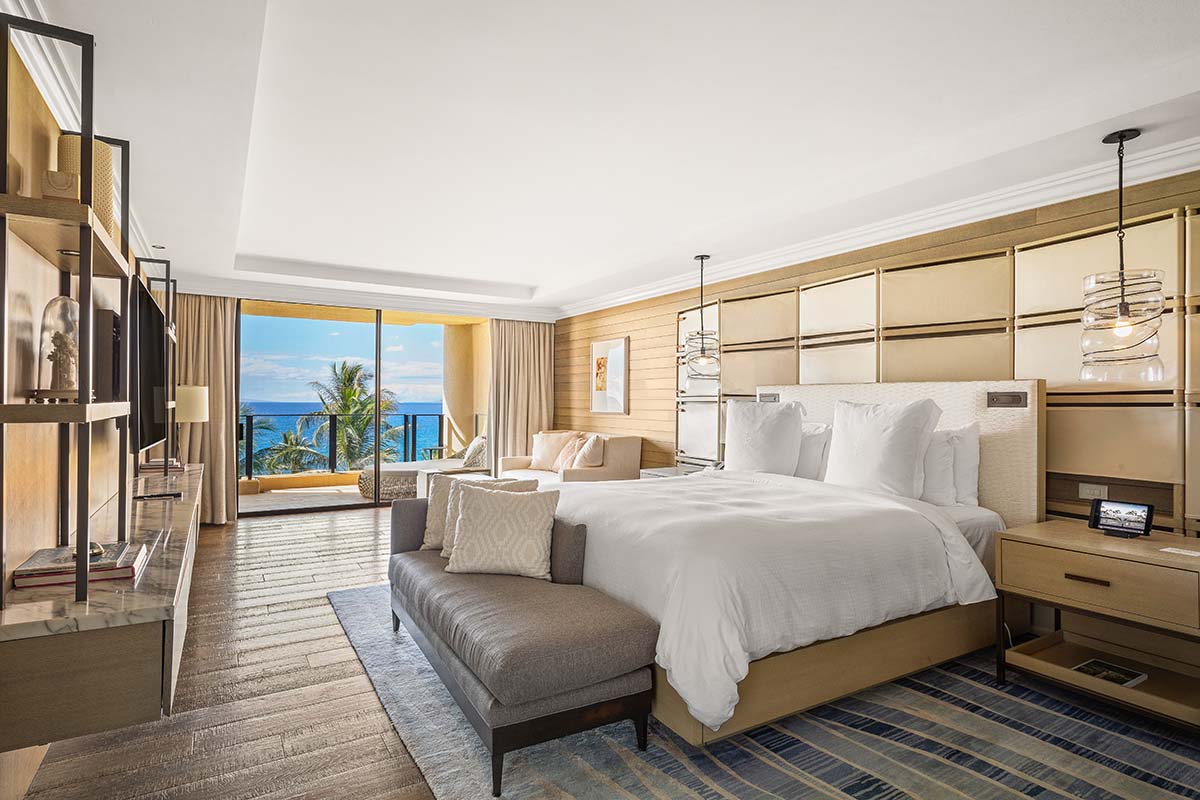 Ocean-view king guest room with warm wood tones and a lanai at Four Seasons Resort Maui, by Niaz Uddin