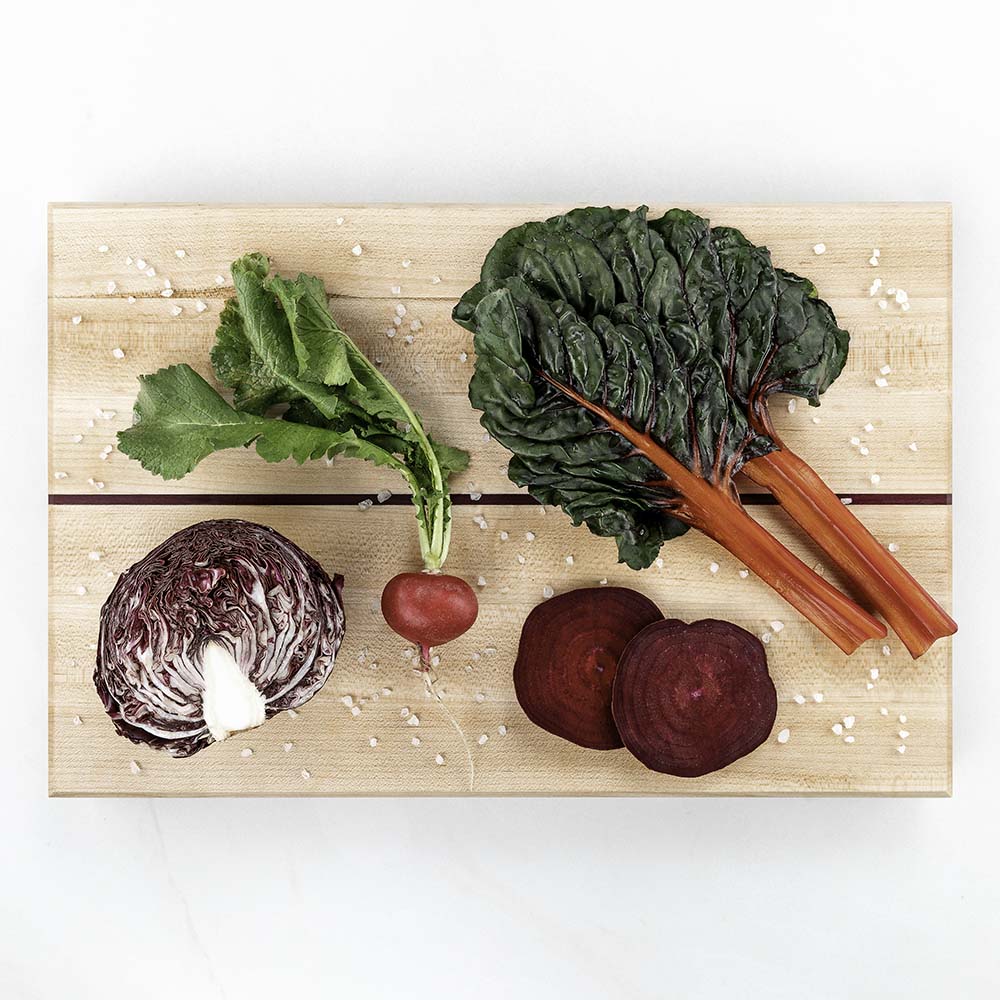 Swiss chard, radicchio, a radish, and sliced beets on a Hawker Woodcraft maple cutting board, by Niaz Uddin