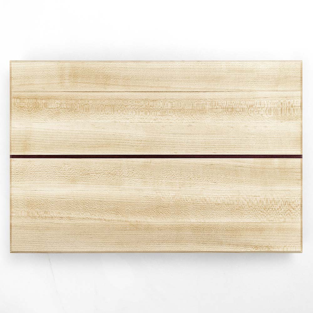 Top-down view of a Hawker Woodcraft maple cutting board with a purpleheart inlay stripe, by Niaz Uddin