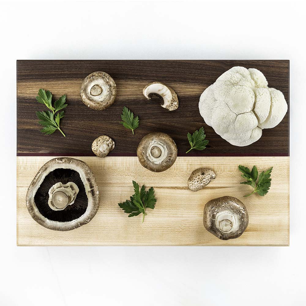 Portobello, cremini, and lion's mane mushrooms with parsley on a two-tone Hawker Woodcraft walnut and maple board, by Niaz Uddin