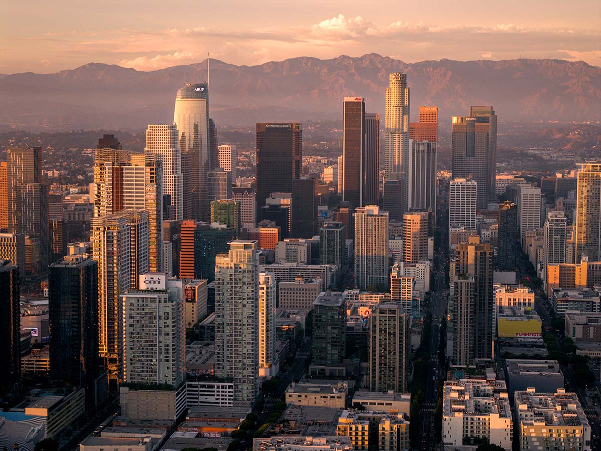 Dusk aerial establishing shot of downtown Los Angeles with the arena and freeway in the foreground, by Niaz Uddin