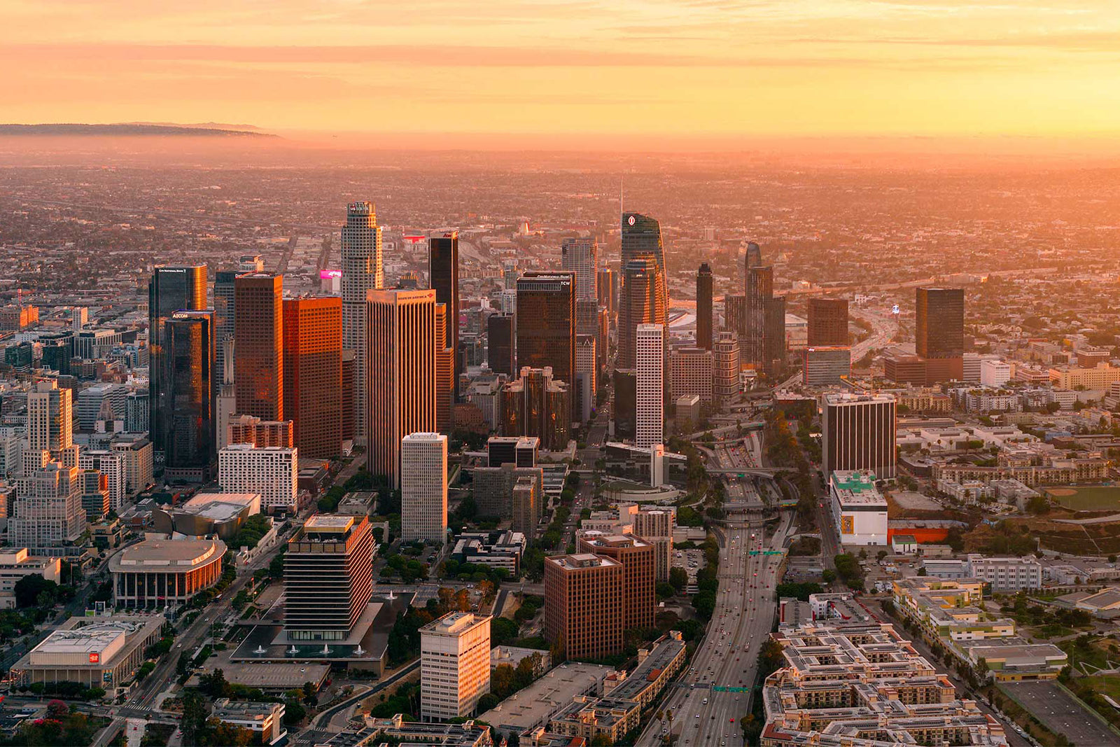 Aerial of the downtown Los Angeles skyline at sunset, by Niaz Uddin