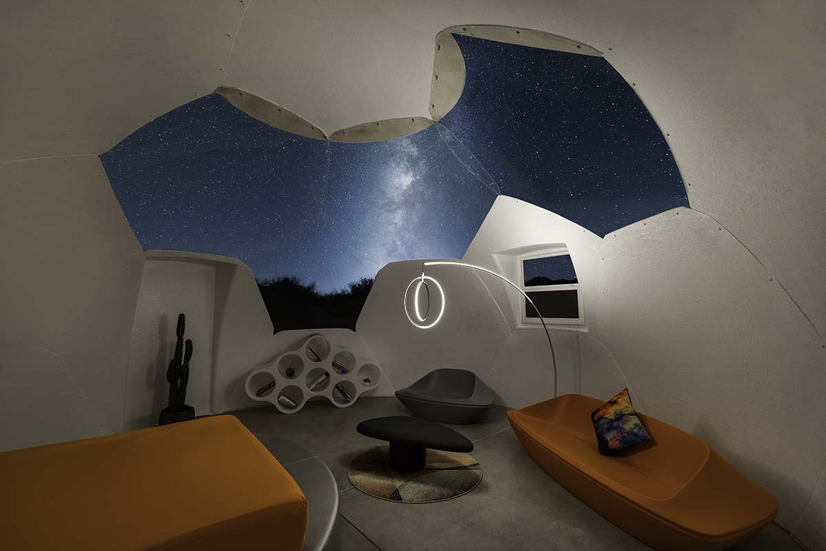 Interior of the domed guest pod at night with the Milky Way visible through the open ceiling, in the Palm Springs desert, by Niaz Uddin