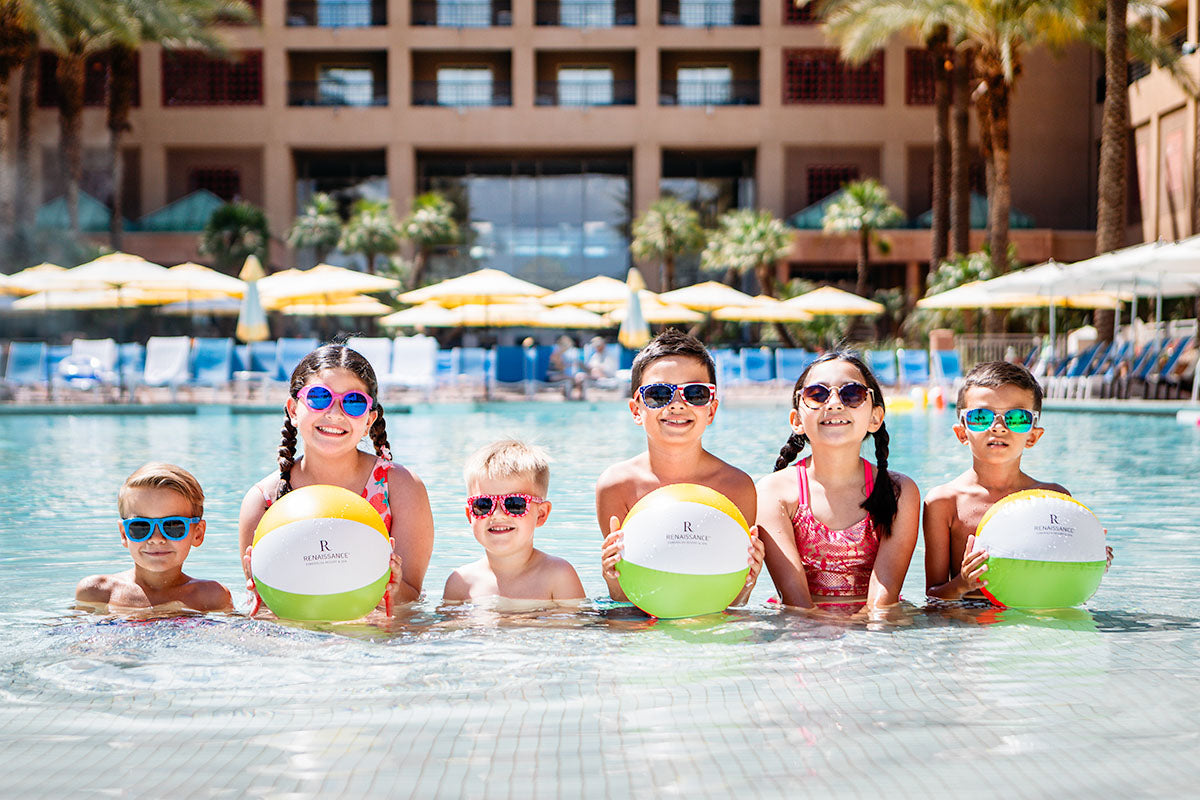 Six children in the pool holding Renaissance beach balls at Renaissance Esmeralda Resort & Spa in Indian Wells