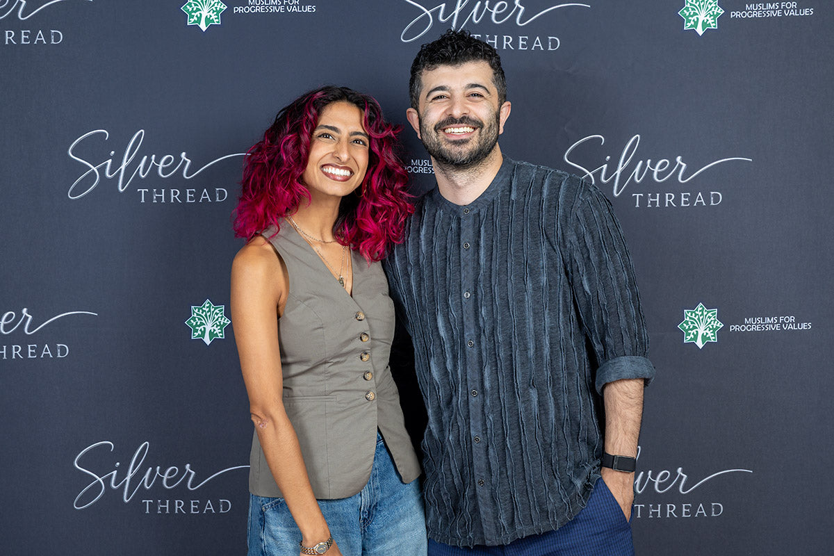 A couple posing together at the Silver Thread step-and-repeat